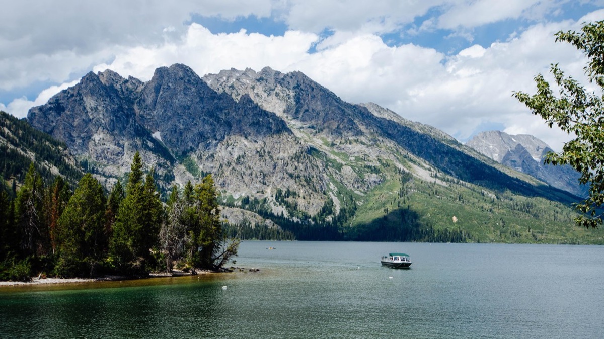 Jenny Lake shuttle boat crossing the lake below the Teton Range