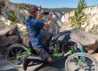 Visitor photographing Lower Falls from an off-road wheelchair at Artist Point in Yellowstone