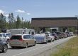 Several lanes of vehicles waiting at Yellowstone National Park’s West Entrance